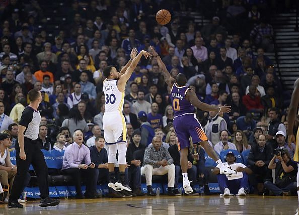 Stephen Curry shoots over the defender