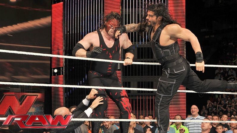 Kane on the receiving end of a Roman Reigns Superman Punch