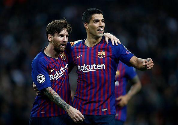 Lionel Messi celebrates with Suarez after scoring against Tottenham