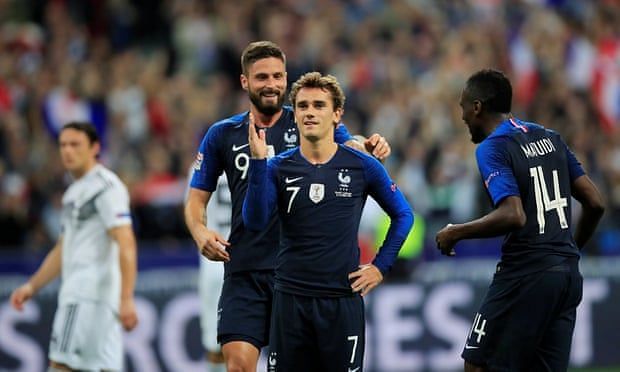 Griezmann celebrates his penalty finish with teammates Giroud and Matuidi