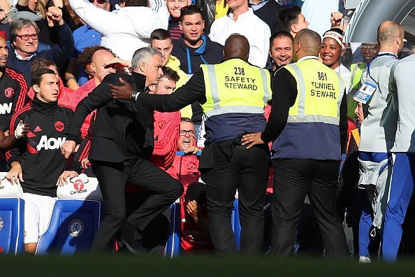 Safety personnel trying to control Mourinho after Chelsea equalized.