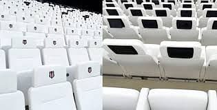 Stadium seats with screens attached to them