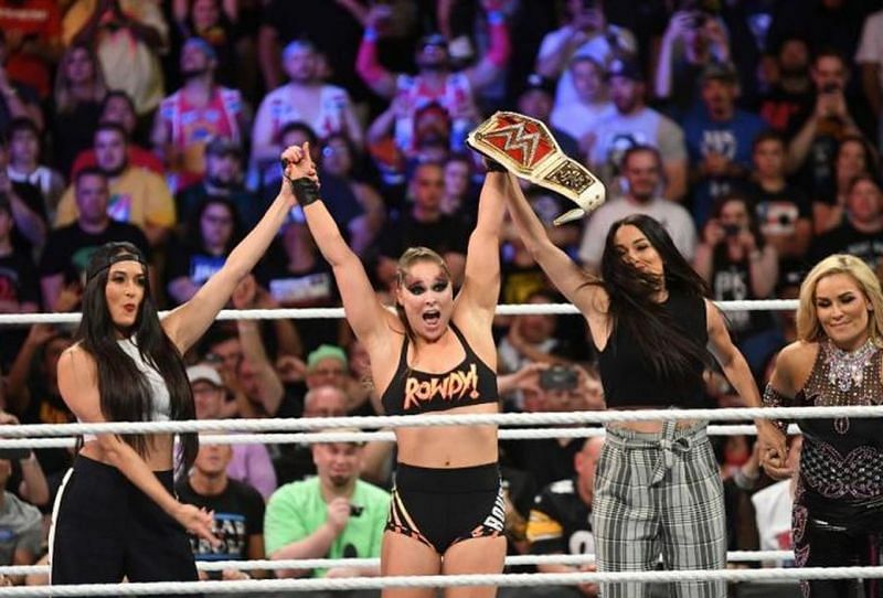 The Bella Twins celebrate with a victorious Rousey at SummerSlam
