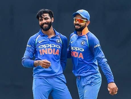 Jadeja (left) celebrates with Indian captain Kohli (right) after picking up a wicket against the West Indies in the 5th ODI