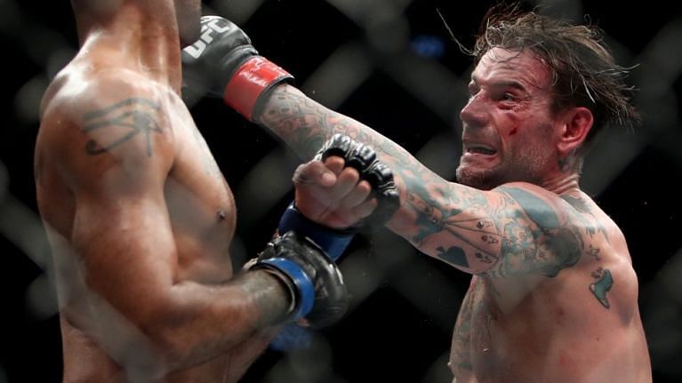 CM Punk throws a left hook in his last fight against Mike Jackson at UFC 225