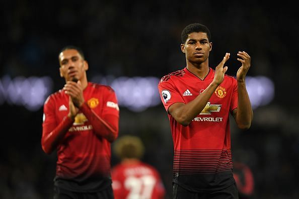 Rashford (right) applauds the fans after United&#039;s frustrating defeat by rivals City