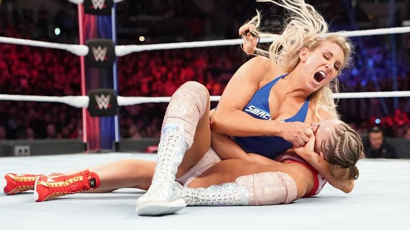 Charlotte Flair with the headlock on Rousey!