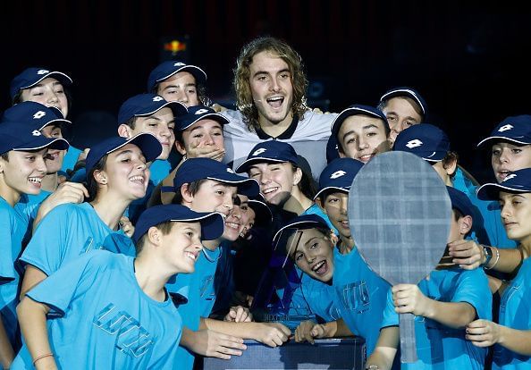 Stefanos Tsitsipas celebrates his Next Gen ATP Finals win with the ballkids