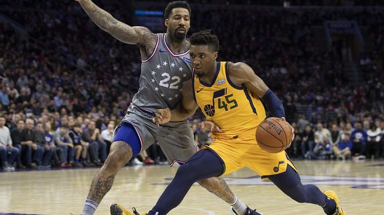 Donovan Mitchell of the Jazz drives on Wilson Chandler of the 76ers.
