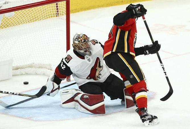 Coach hit by puck, Flames rout Coyotes 6-1