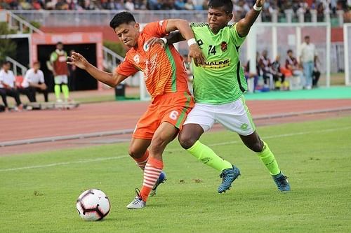 Abhishek Das (right) of Gokulam Kerala FC goes for a tackle on Ashok Moirangmayum of NEROCA FC