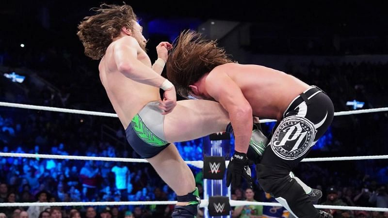 With the official down on the canvas, Bryan kicks Styles below the belt...