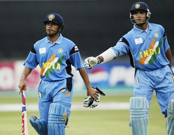 Sachin Tendulkar (left) of India is given a pat on the back by his partner