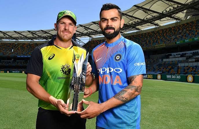 Aaron Finch and Virat Kohli pose with Trophy