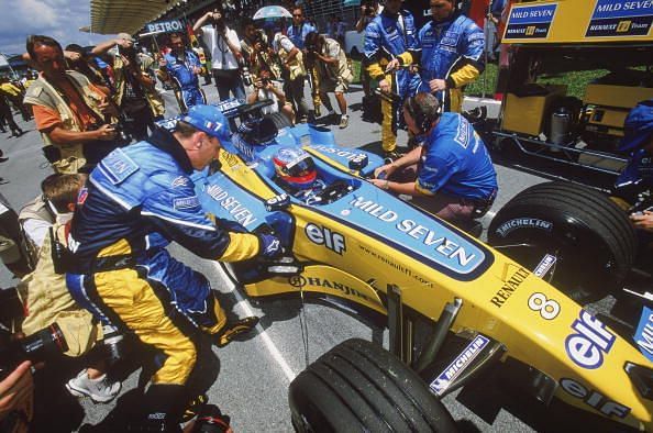 Fernando Alonso of Spain and the Renault team in the pits after claiming pole position