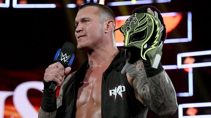 Orton poses with the stolen mask of Rey Mysterio.
