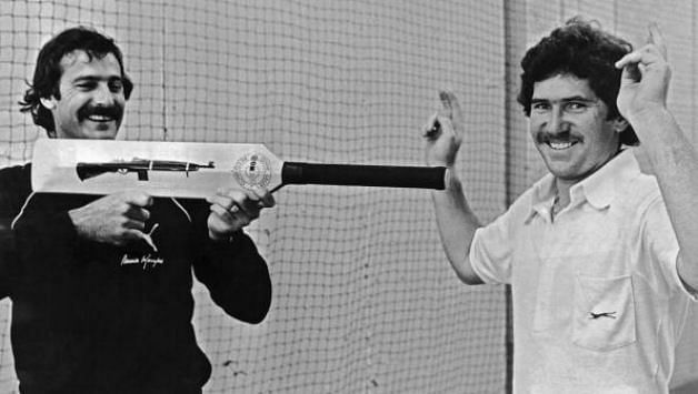 Dennis Lillee threatens Allan Border with his aluminum bat in a light-hearted gesture
