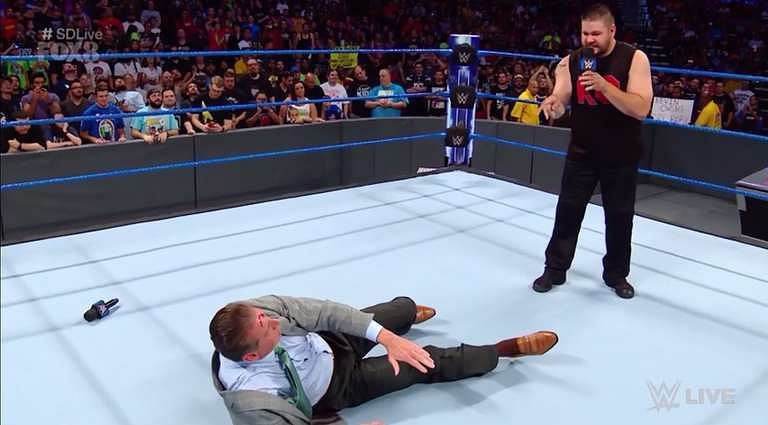 K. O. Kevin Owens stands over a bloody and bedraggled Vincent Kennedy McMahon on RAW.