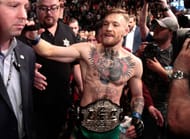 Conor McGregor walks out of the Octagon as the new Featherweight Champion