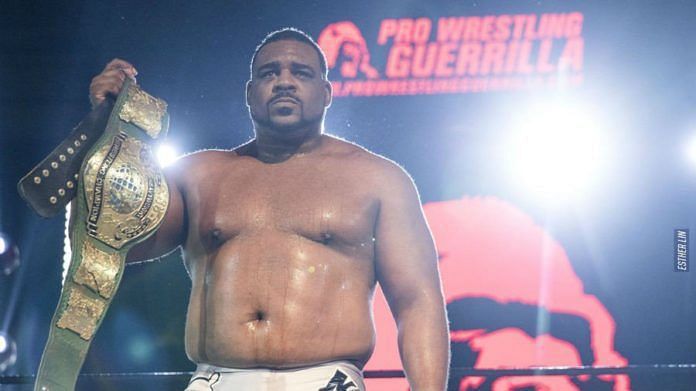 Keith Lee proudly holds the Pro Wrestling Guerrilla championship belt.