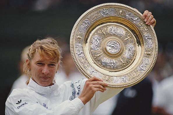 Steffi Graf lifts the Wimbledon Lawn Tennis Championship trophy in 1996