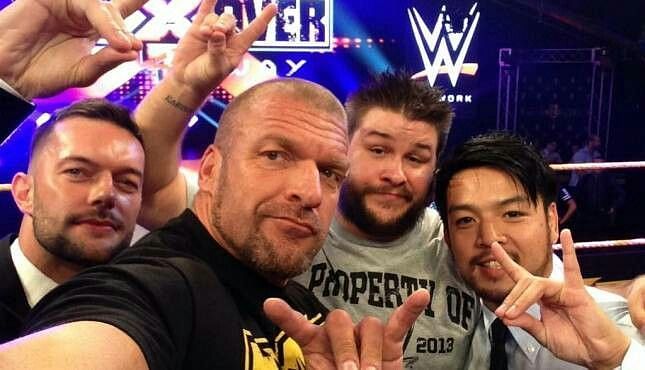 Triple H with Finn Balor, Kevin Owens, and Hideo Itami