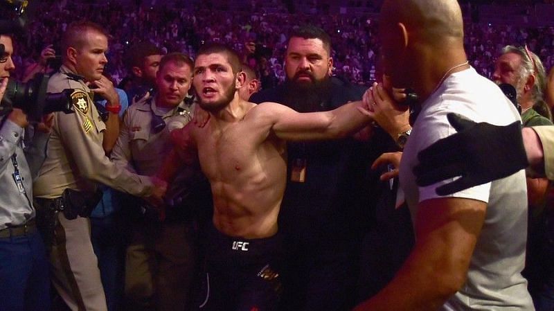 Khabib is restrained by security and police in the post-main event brawl