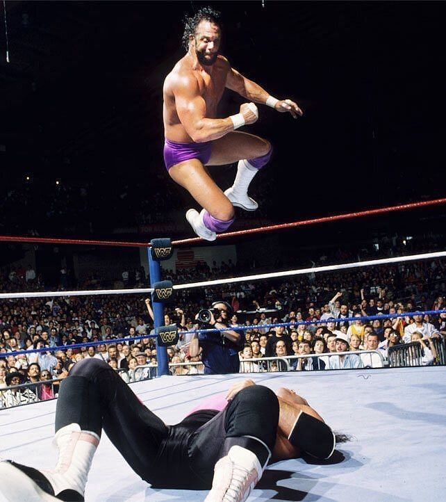 Macho Man Randy Savage unleashes a flying elbow drop, a move he made famous, on the helpless Bret the Hitman Hart