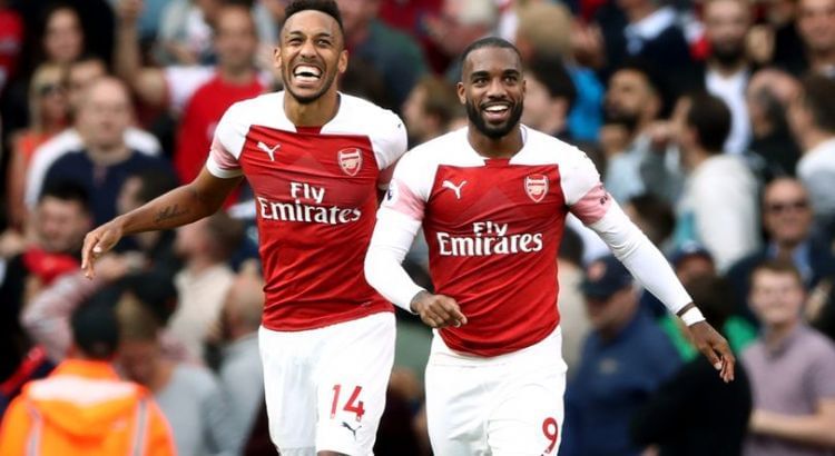 Pierre-Emerick Aubameyang and Alex Lacazette smile after a goal.