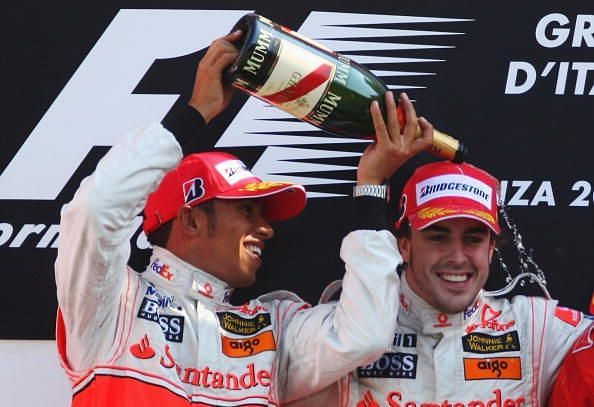 Hamilton pours champagne over Alonso at the 2007 Italian Formula One Grand Prix trophy presentation