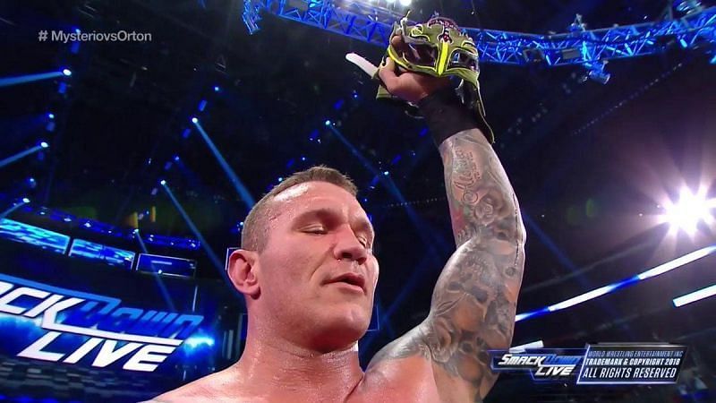 Randy Orton showing off Rey&#039;s Mask as a trophy.