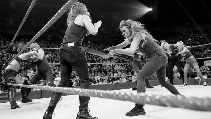 Becky attacks Ronda Rousey with a chair.