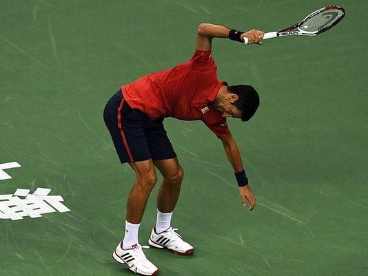 Djokovic smashes his racket on the ground