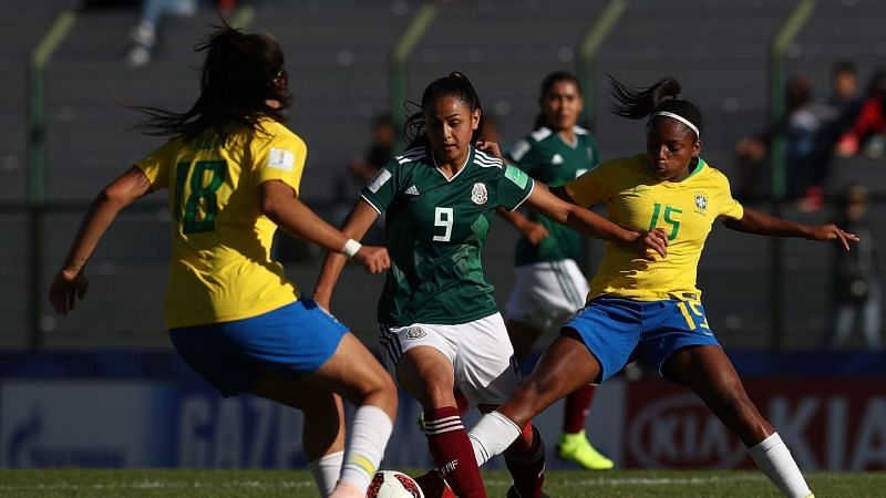 Number 9 Vanessa Buso from Mexico in action with Number 15 Miriam Cristina of Brazil