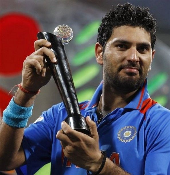 Yuvi holding his Man of the Tournament award from 2011 World Cup