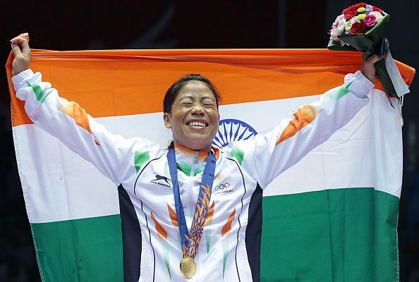 Mary Kom is happily holding tricolour after winning a gold medal at Asian Games