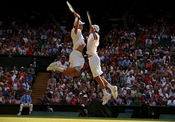 The Bryan twins - the most successful Doubles pair of all-time doing their customary chest bump celebration after winning the Wimbledon Championships in 2013