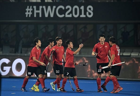 Chinese players celebrating after scoring a goal against Ireland during the 2018 Hockey World Cup
