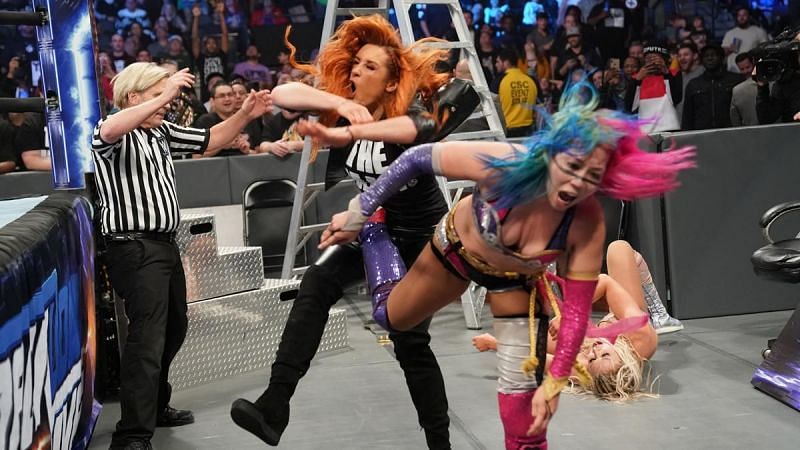 Asuka blasts The Man with a vicious kick.