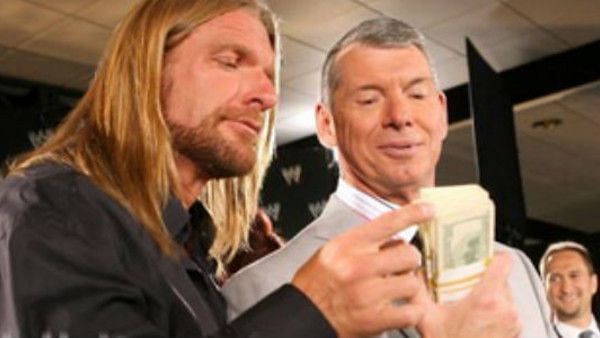 Triple H with hair and Vince McMahon going over business.