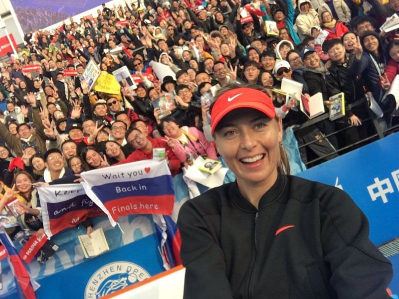 Maria Sharapova takes a picture with her fans after her opening round win at the Shenzhen Open