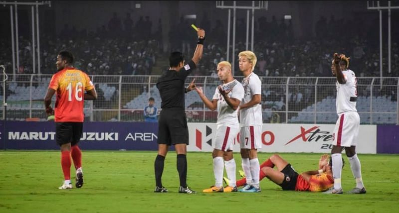 Mohun Bagan players argue after Eze Kingsley (right) is shown a yellow card