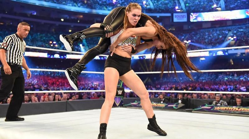 Ronda Rousey getting ready to slam Stephanie McMahon during their match at WrestleMania 34.