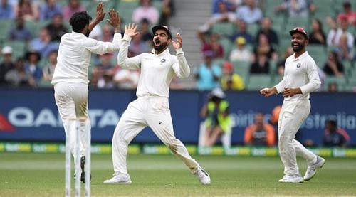 Virat Kohli (C) and Ravindra Jadeja celebrate a wicket