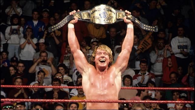 Rowdy Roddy Piper hefts the WWE Intercontinental championship proudly.