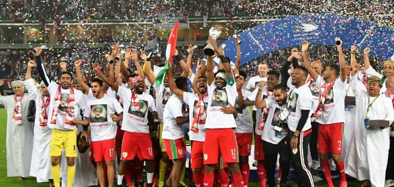 Omani players and staff celebrate after lifting the Arabian Gulf Cup in January 2018