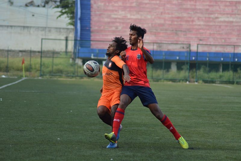 South United FC&#039;s Mani is clattered by a Bangalore Independents defender