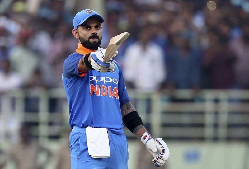 Virat Kohli raises his bat after scoring his 37th ODI century