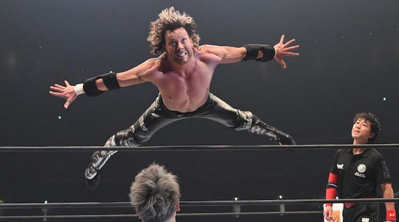 Kenny Omega flies over the top rope in New Japan Pro Wrestling