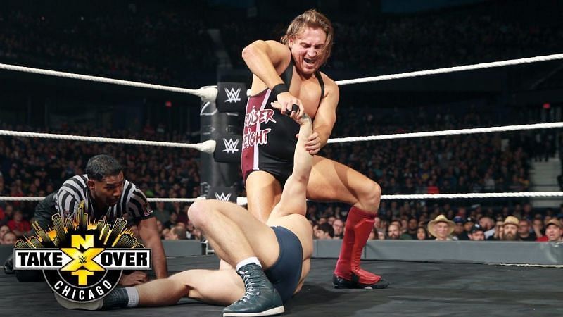 Bruiserweight Pete Dunne applies a joint lock to a suffering but not out Tyler Bate.